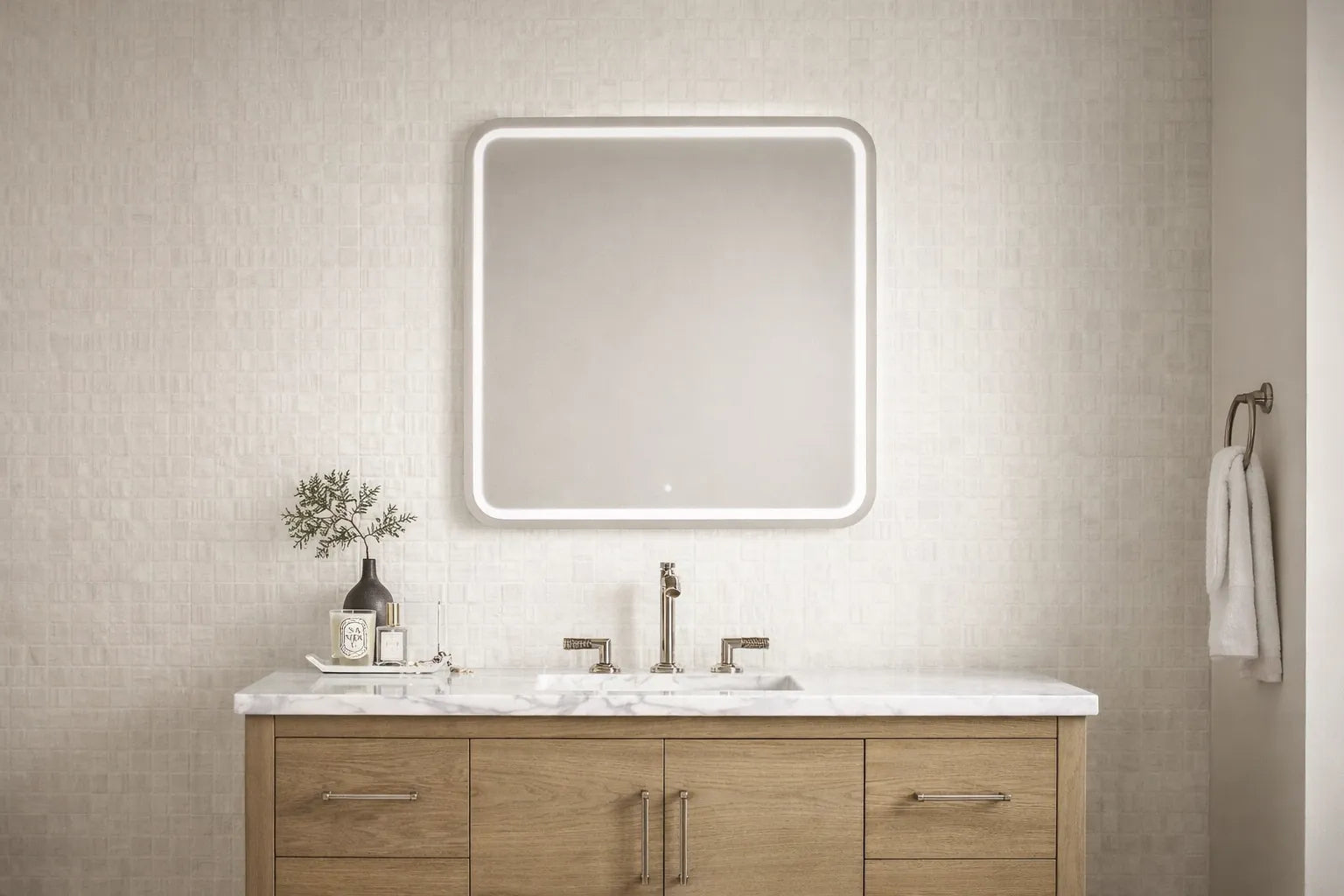 LED bathroom mirror mounted over a vanity, showing balanced height and centering