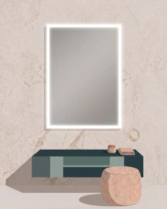 A modern wall-mounted rectangular mirror with a glowing white LED light border, set above a dark teal floating vanity shelf with small decorative objects, against a textured beige plaster wall.
