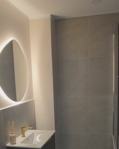 Asymmetrical LED mirror with rear lighting 740x790mm in bathroom